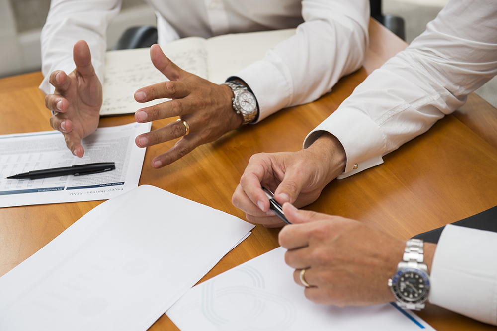 Lifestyle close-up of boardroom meeting for use on company website