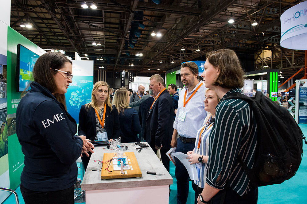 Delegates watching demonstration at exhibition stand.