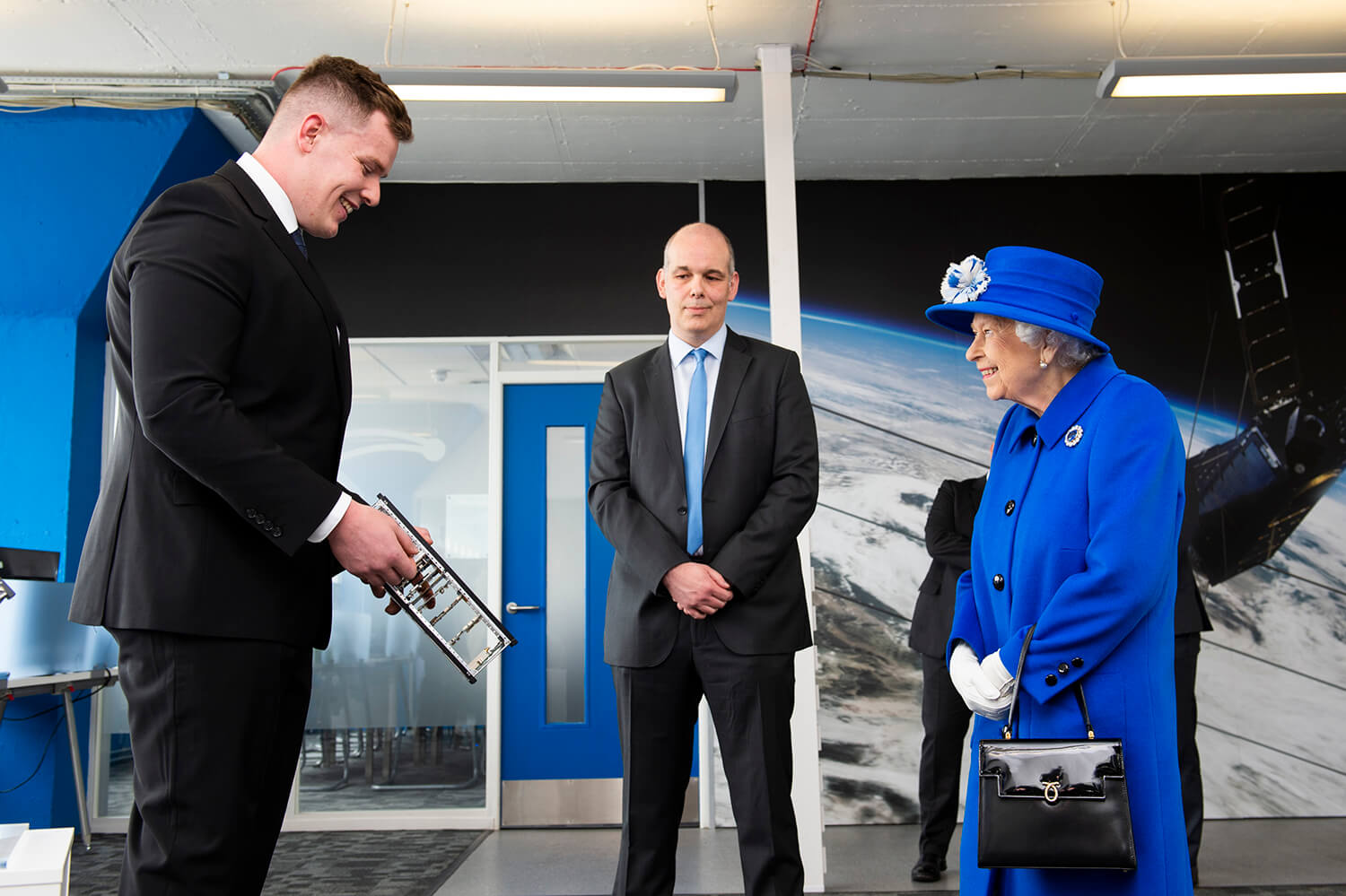 Queen taking to employee during Royal Visit