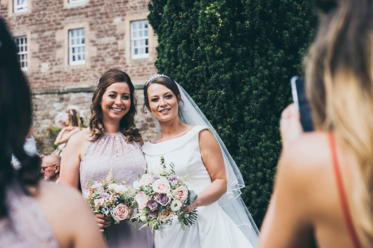 Bride and bridesmaid at drinks reception by Glasgow wedding photographers Richard Campbell Photography