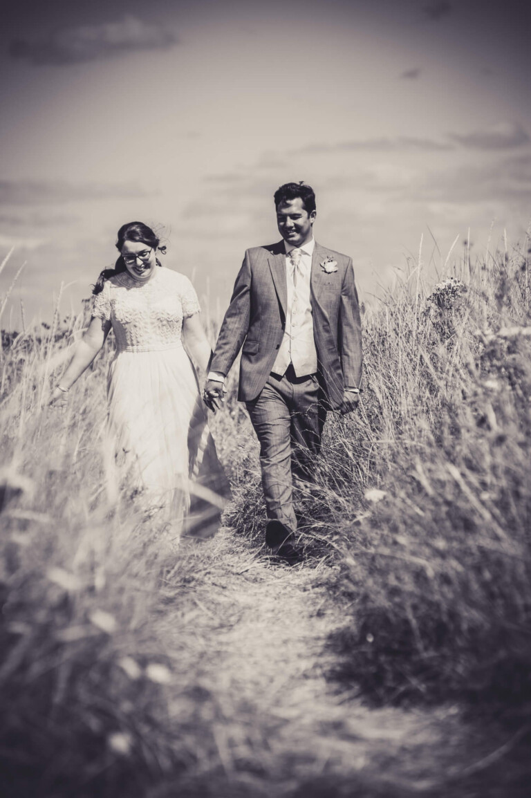 Natural photography of bride and groom walking along beach by Glasgow wedding photographer Richard Campbell