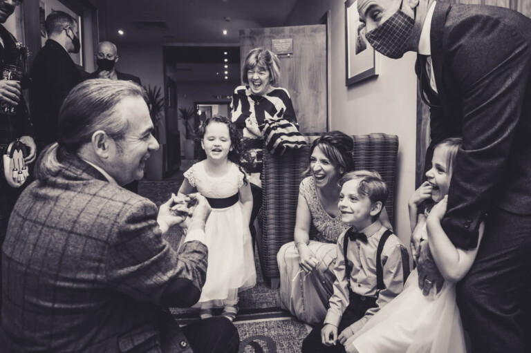 Magician entertaining guests by Glasgow wedding photographers Richard Campbell